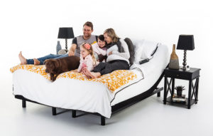 Image of a family and their dog enjoying time together on their adjustable bed